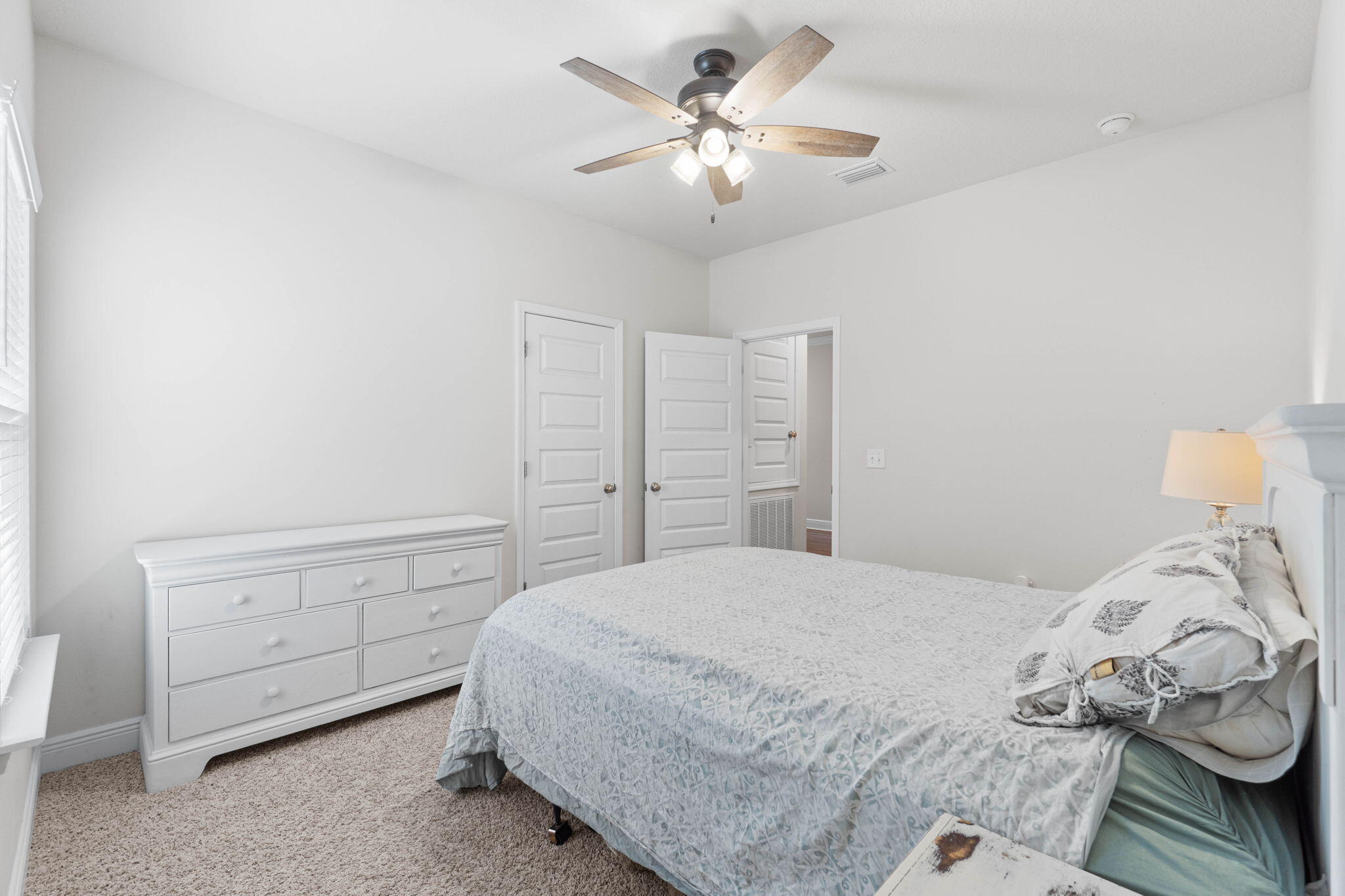 371 Lightning Bug Lane Freeport, FL 32439 - Photo 19 of 56 a bedroom with a bed and a chandelier
