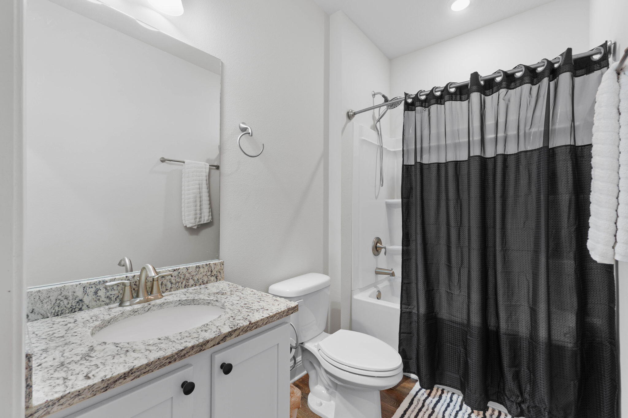 371 Lightning Bug Lane Freeport, FL 32439 - Photo 20 of 53 a bathroom with a granite countertop sink toilet and shower