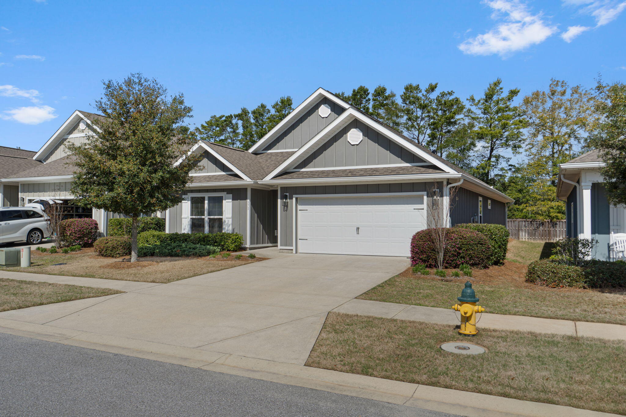371 Lightning Bug Lane Freeport, FL 32439 - Photo 2 of 56 a front view of a house with yard and parking