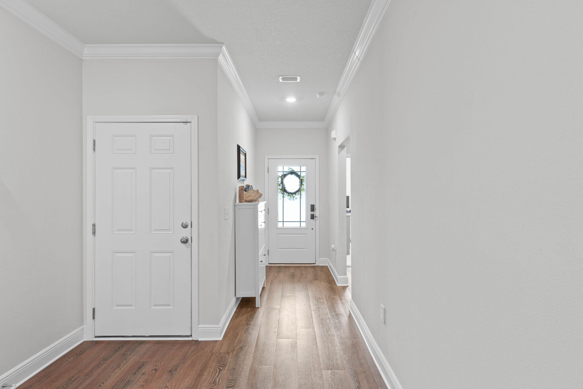 371 Lightning Bug Lane Freeport, FL 32439 - Photo 4 of 56 a view of a hallway with wooden floor