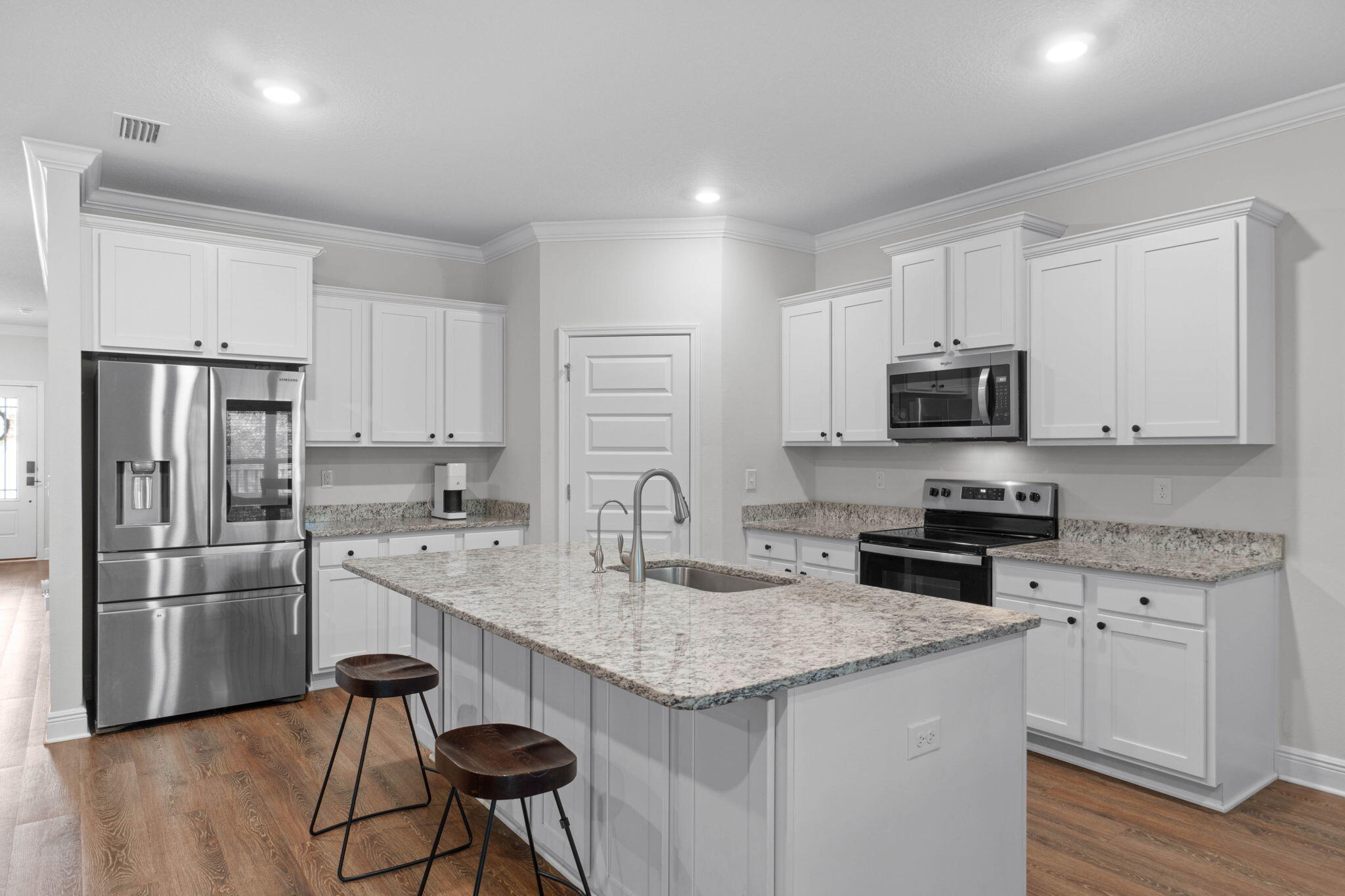 371 Lightning Bug Lane Freeport, FL 32439 - Photo 10 of 56 a kitchen with stainless steel appliances granite countertop a stove a sink a refrigerator and white cabinets