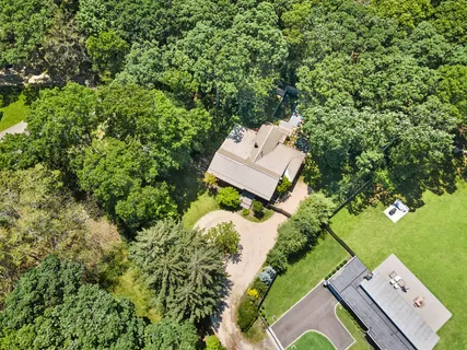 an aerial view of a house with a yard
