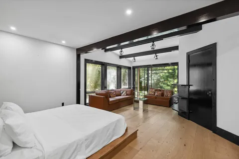 a bed room with a bed and a large window