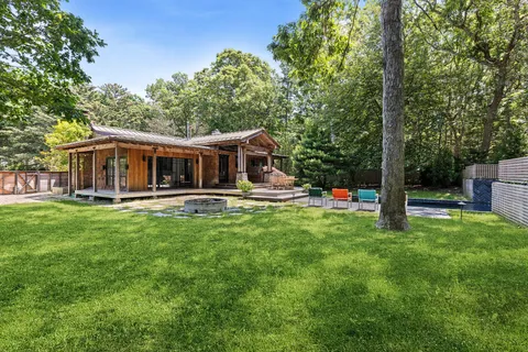 a view of a house with a backyard porch and sitting area