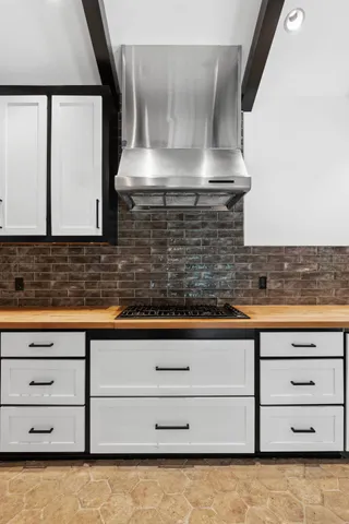 a bathroom with a granite countertop sink and a stove