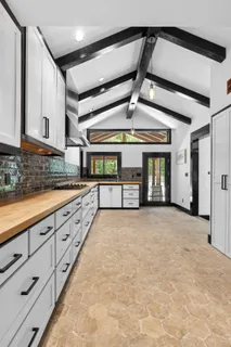 a spacious bathroom with stainless steel appliances granite countertop a sink and cabinets