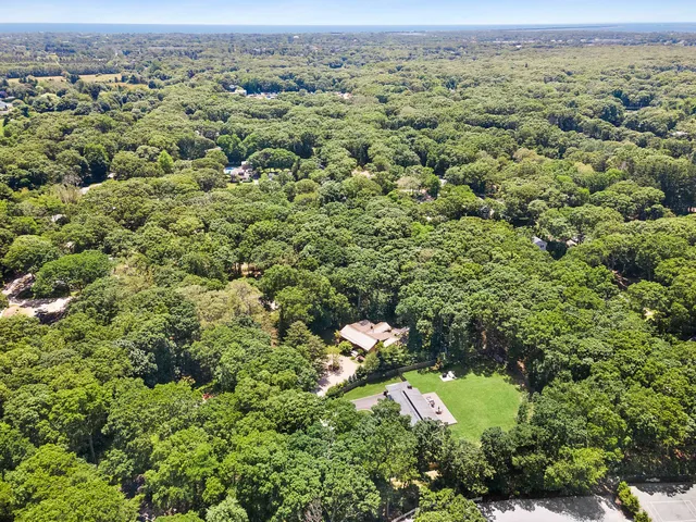 an aerial view of a houses with a yard