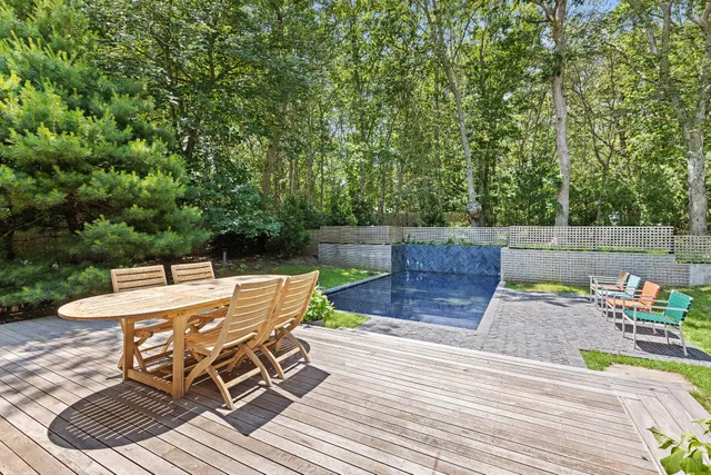 a view of a patio with table and chairs and potted plants