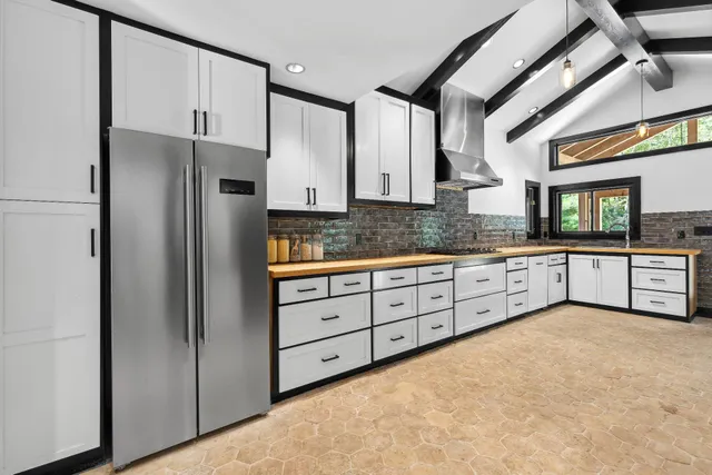 a kitchen with granite countertop a refrigerator and a sink