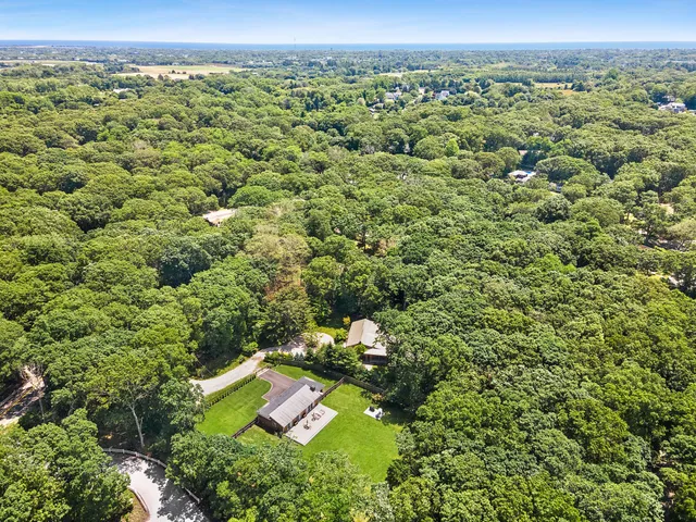 an aerial view of a house with a yard