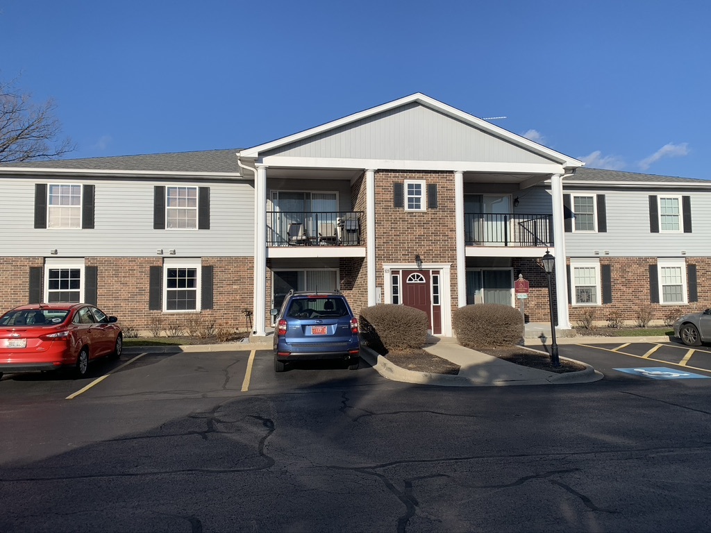 929 Golf Course Road, Unit 1 Crystal Lake, IL 60014 - Photo 1 of 2 a front view of a house with parking space