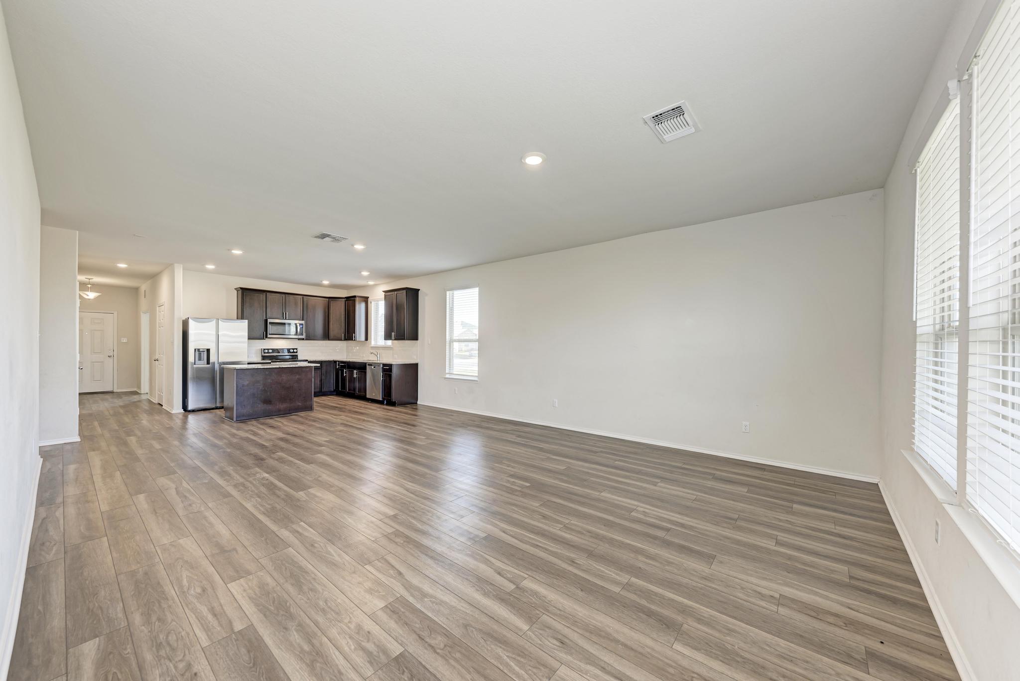 201 Pivot Drive Taylor, TX 76574 - Photo 13 of 34 a view of kitchen and livingroom with furniture wooden floor kitchen view