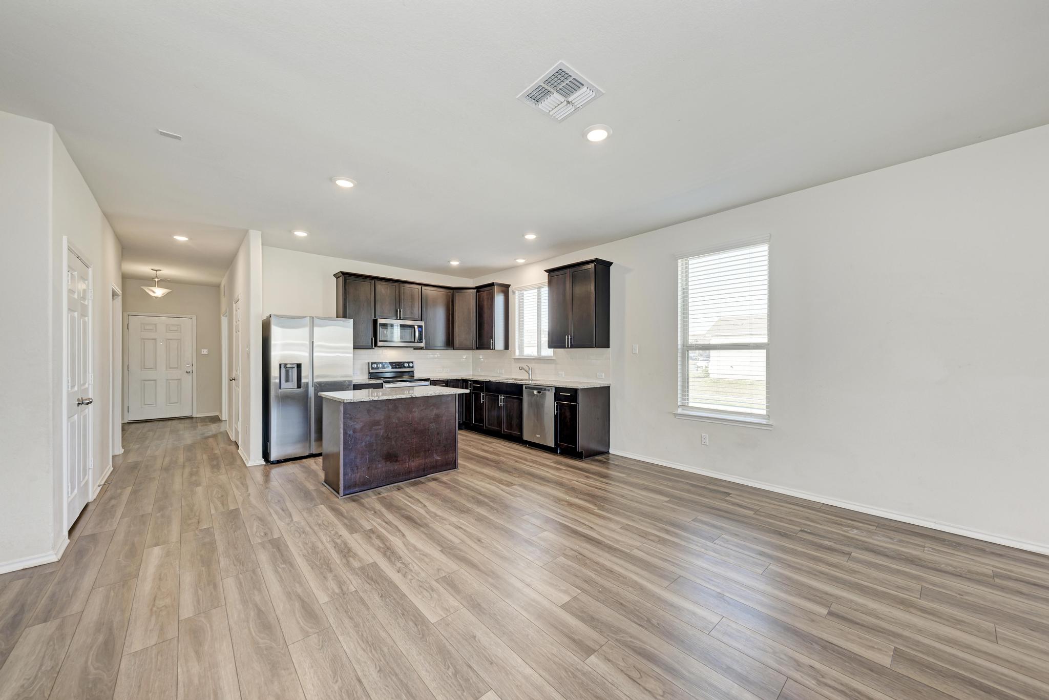 201 Pivot Drive Taylor, TX 76574 - Photo 14 of 34 a large kitchen with stainless steel appliances granite countertop a large counter top and a sink