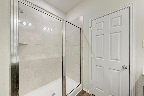 a bathroom with a glass shower door
