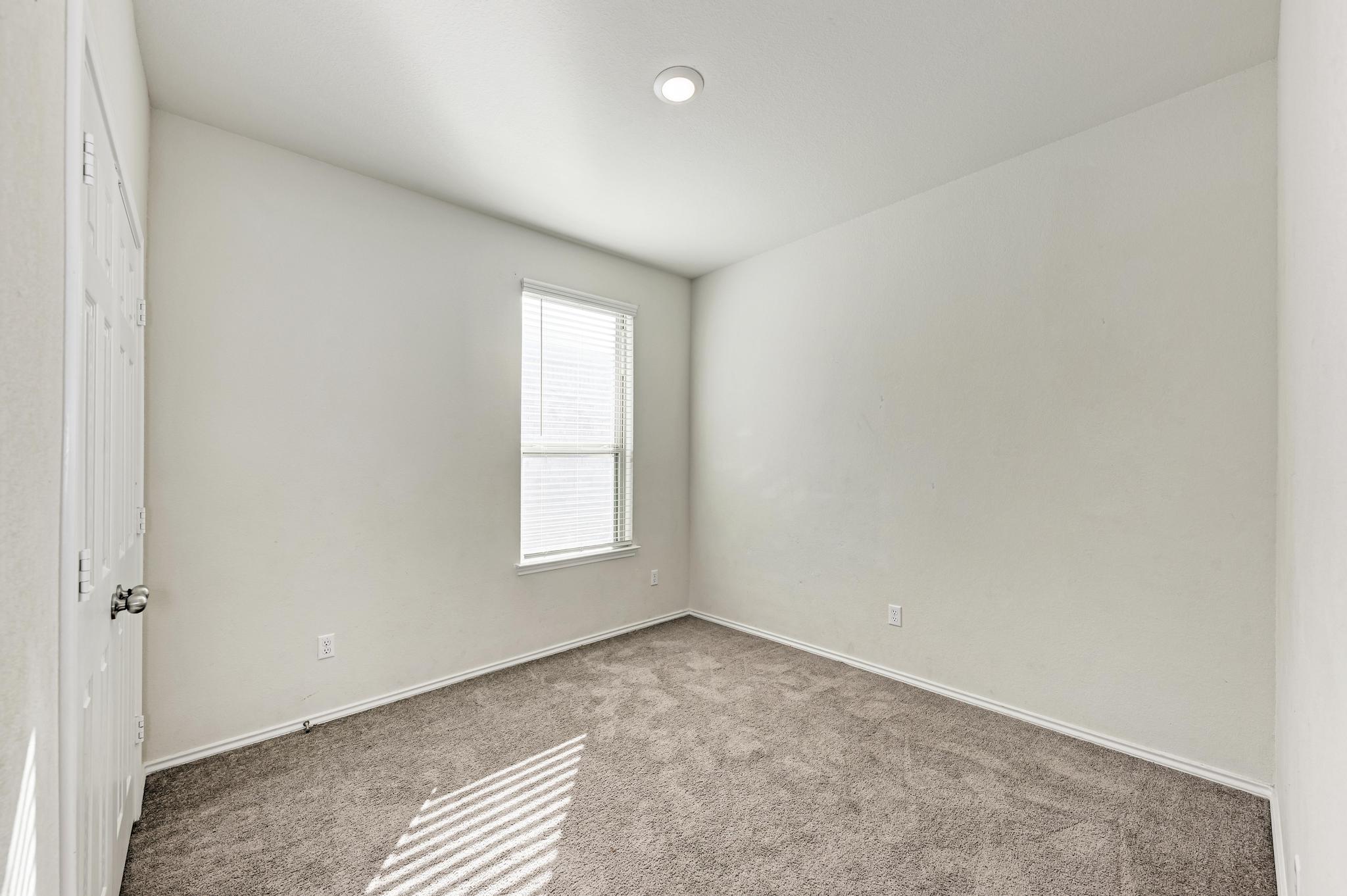 201 Pivot Drive Taylor, TX 76574 - Photo 20 of 34 an empty room with windows