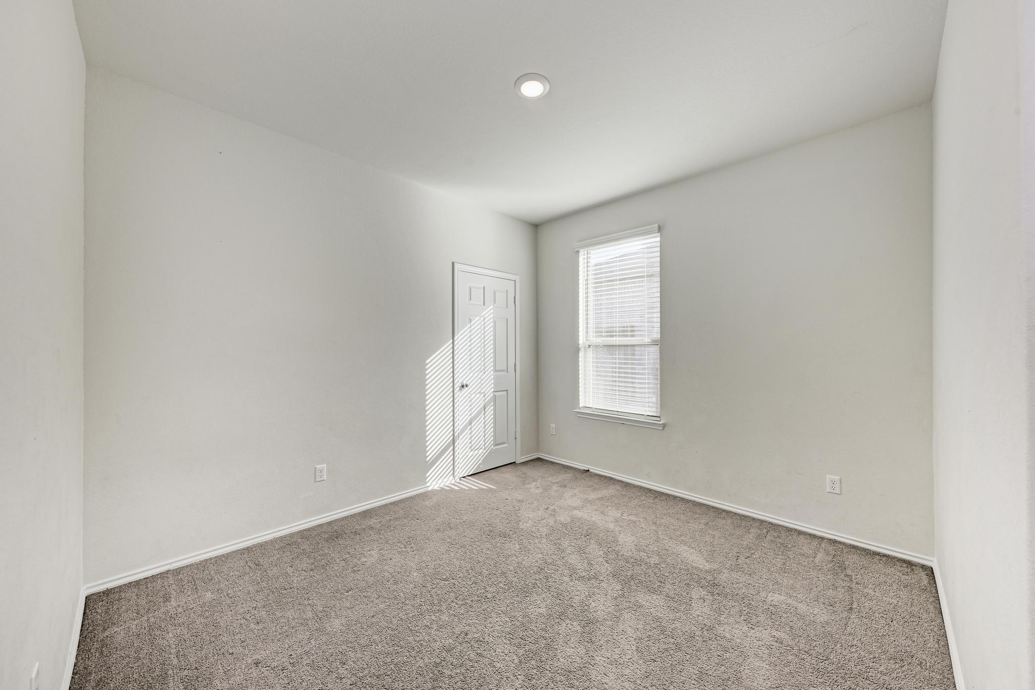 201 Pivot Drive Taylor, TX 76574 - Photo 24 of 34 an empty room with windows