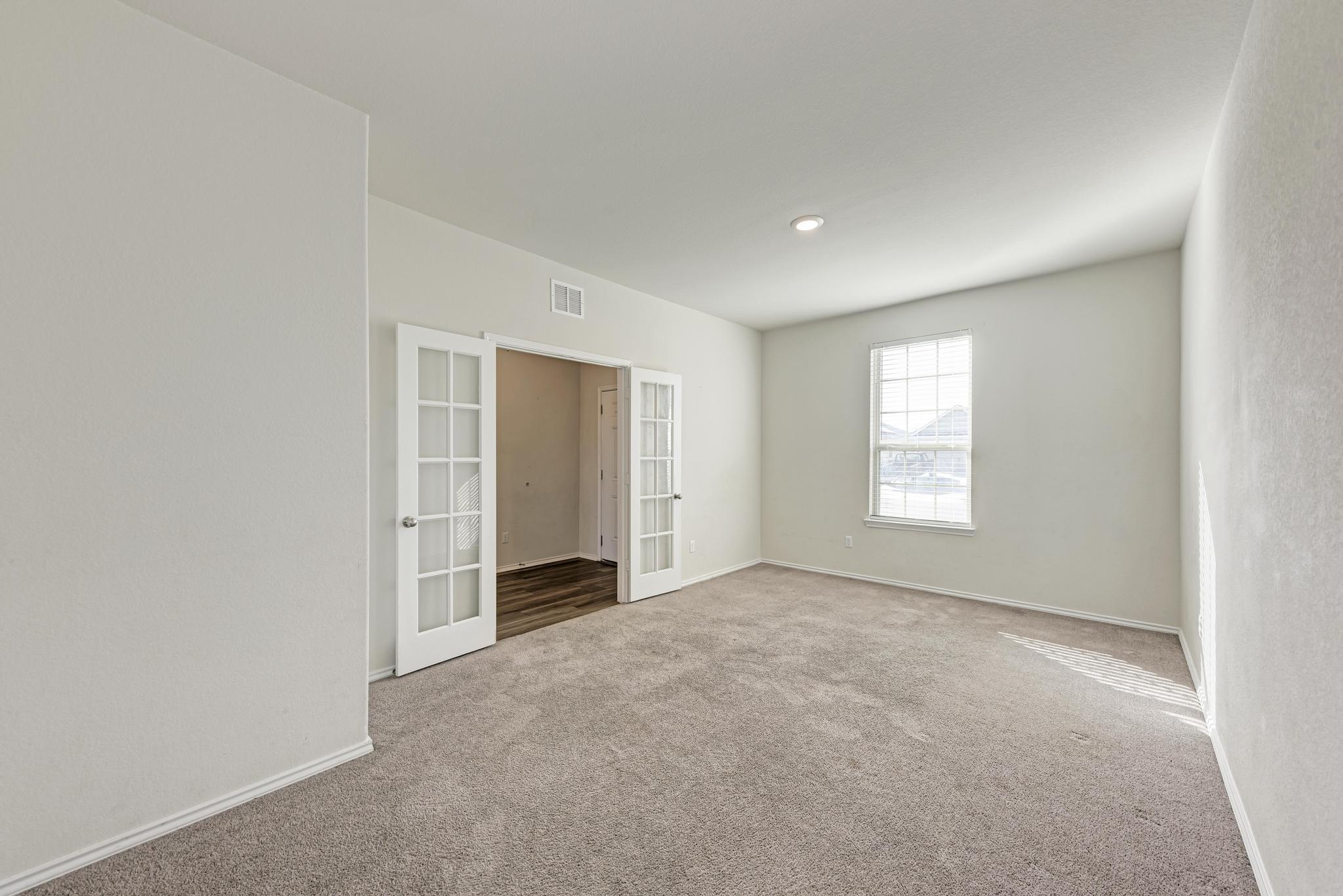 201 Pivot Drive Taylor, TX 76574 - Photo 26 of 34 an empty room with windows