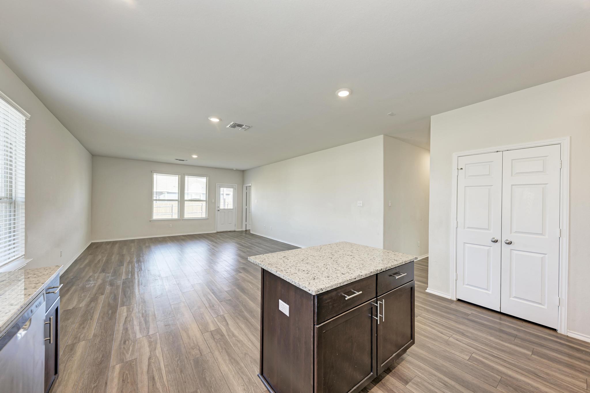 201 Pivot Drive Taylor, TX 76574 - Photo 8 of 34 an empty room with wooden floor and windows