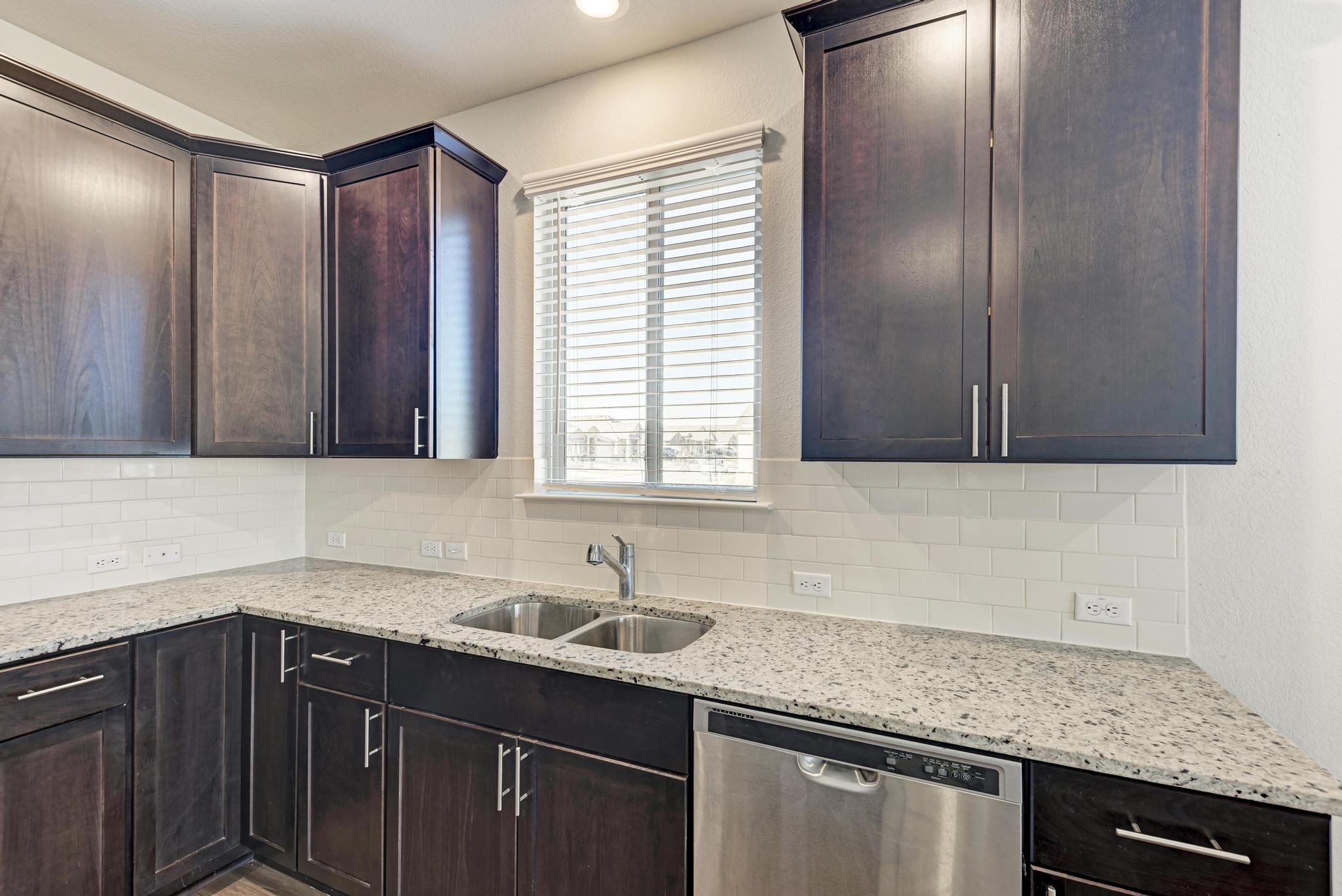 201 Pivot Drive Taylor, TX 76574 - Photo 9 of 34 a kitchen with a sink cabinets and window