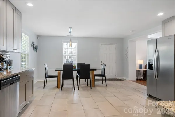 a view of a kitchen with dining area windows and chandelier