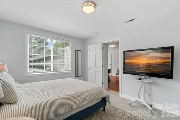 a bedroom with a bed and a flat screen tv