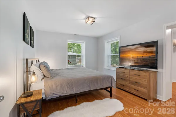 a bedroom with furniture and a flat screen tv