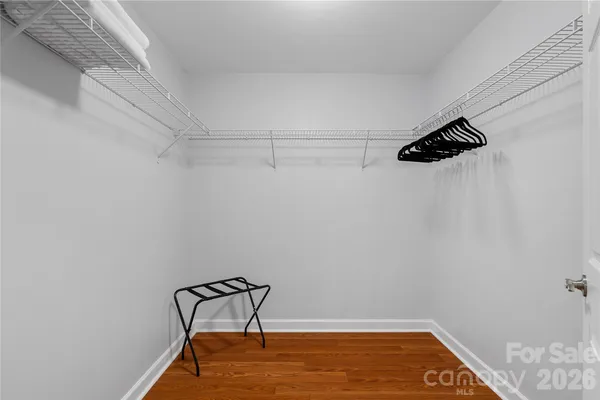 a room with a hanging light and a ceiling fan