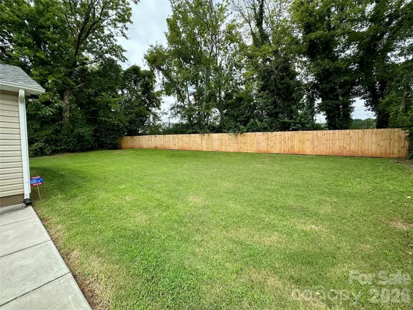 a view of a yard with large trees