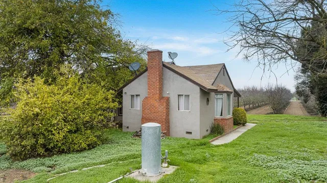 a front view of house with yard and trees