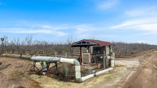 a view of a roof deck with table and chairs under an umbrella