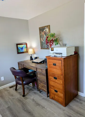 a bedroom with a bed and a desk