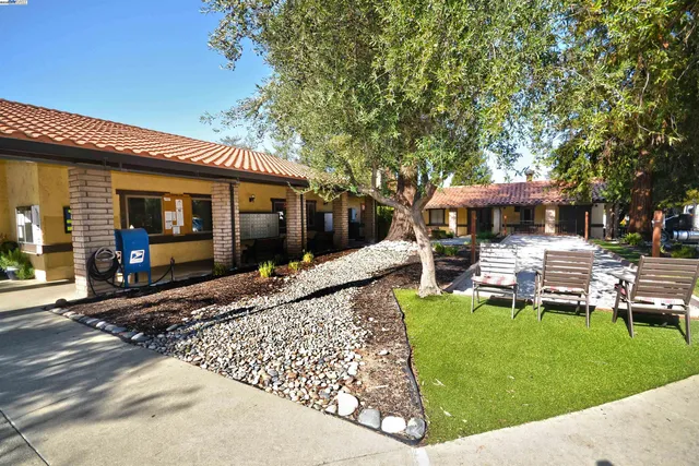 a view of a house and a swimming pool and sitting area