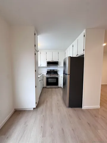 a kitchen with granite countertop a refrigerator and a stove