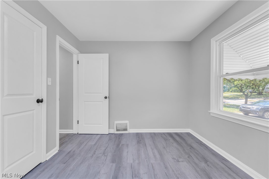5581 Dunham Road Maple Heights, OH 44137 - Photo 18 of 33 Unfurnished room featuring wood-type flooring