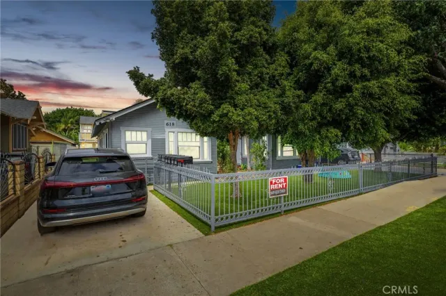 a view of a hallway with entryway wooden floor and front door