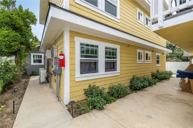 a view of a house with potted plants