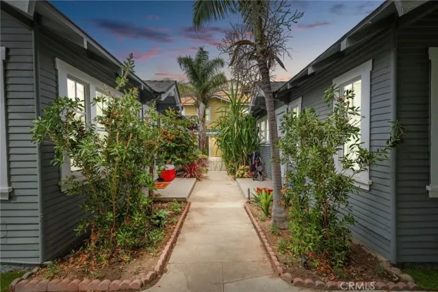 a view of a pathway along with potted plants