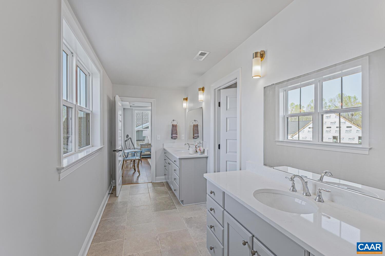 1731 Fowler Street Charlottesville, VA 22901 - Photo 25 of 45 a spacious bathroom with a double vanity sink a mirror a shower and a bathtub