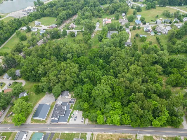 a view of a city from a lush green forest