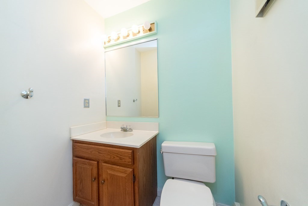 4 Jill Lane, Unit A Sterling, MA 01564 - Photo 14 of 38 a bathroom with a toilet a sink and mirror