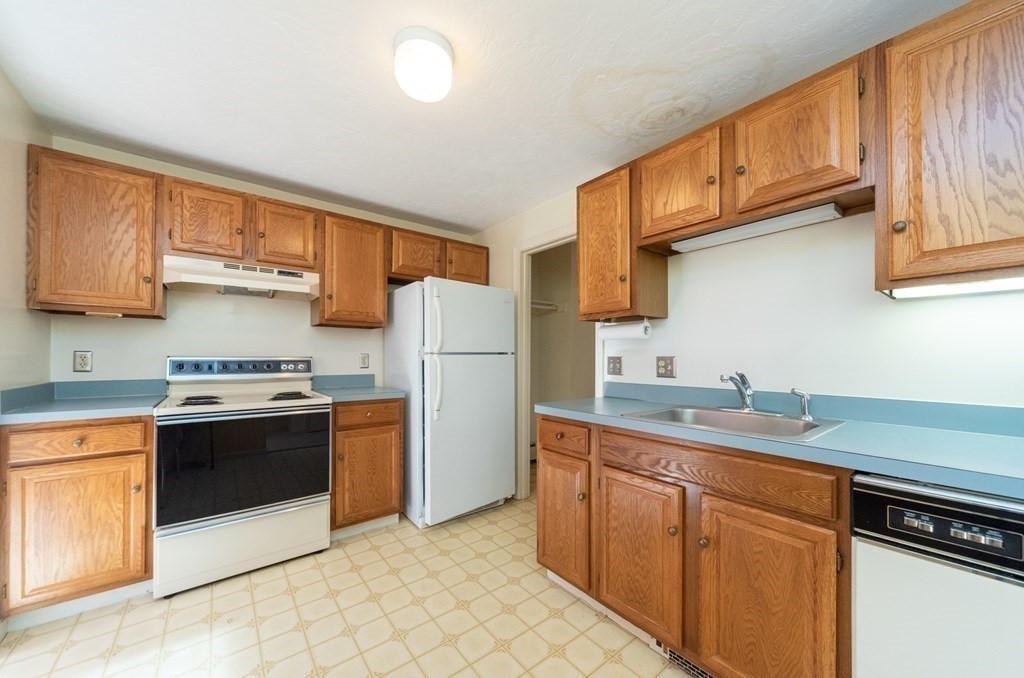 4 Jill Lane, Unit A Sterling, MA 01564 - Photo 6 of 38 a kitchen with stainless steel appliances granite countertop a stove a sink dishwasher and a refrigerator