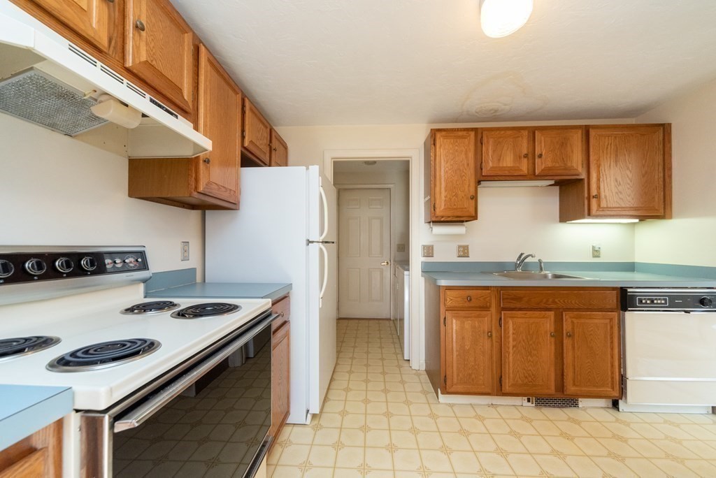 4 Jill Lane, Unit A Sterling, MA 01564 - Photo 7 of 38 a kitchen with stainless steel appliances granite countertop a stove and a refrigerator