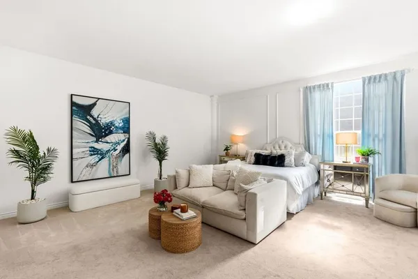 a bedroom with bed and a couch