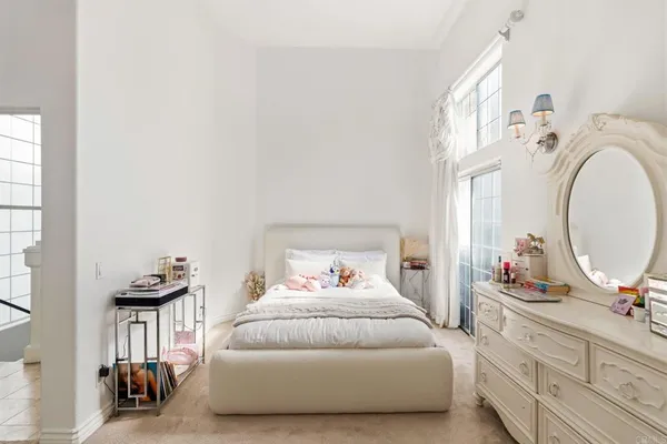 a bedroom with a bed and a mirror