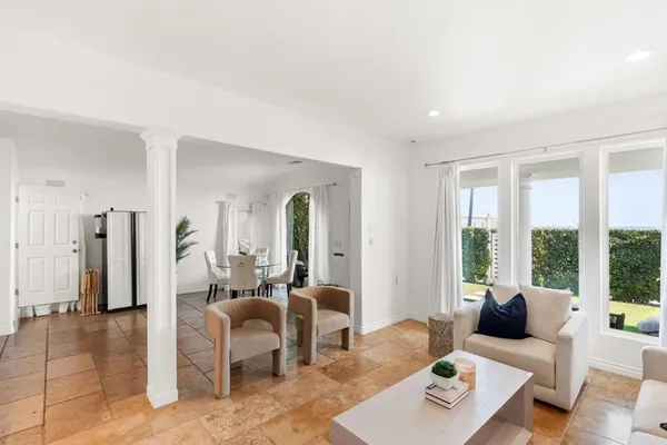 a living room with furniture and large windows