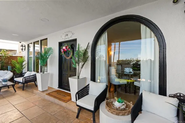 a living room with furniture and a floor to ceiling window