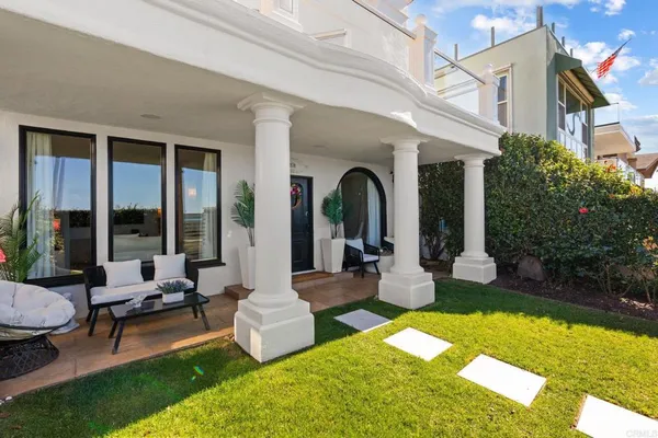 a front view of a house with garden and patio