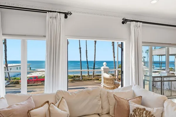 a living room with furniture and a floor to ceiling window