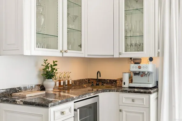 a kitchen with granite countertop stainless steel appliances a stove a sink and a microwave