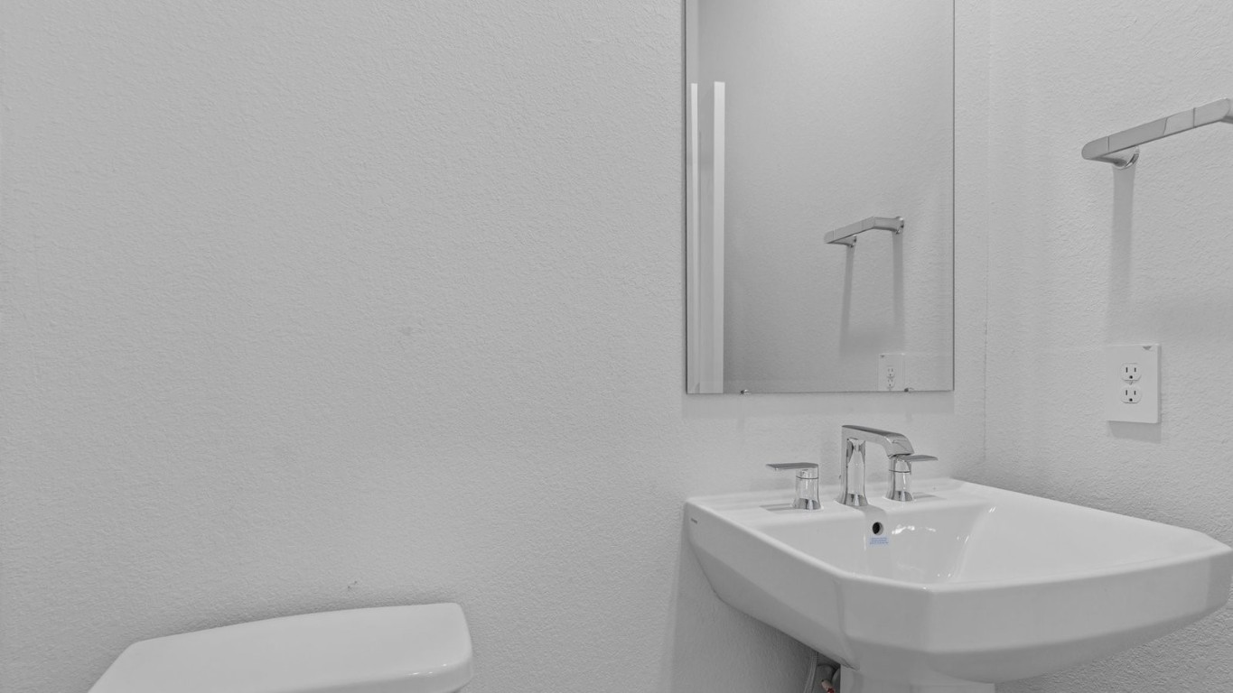 6324 Cherry Mdws Street Rosenberg, TX 77469 - Photo 5 of 41 a bathroom with a toilet a sink and mirror